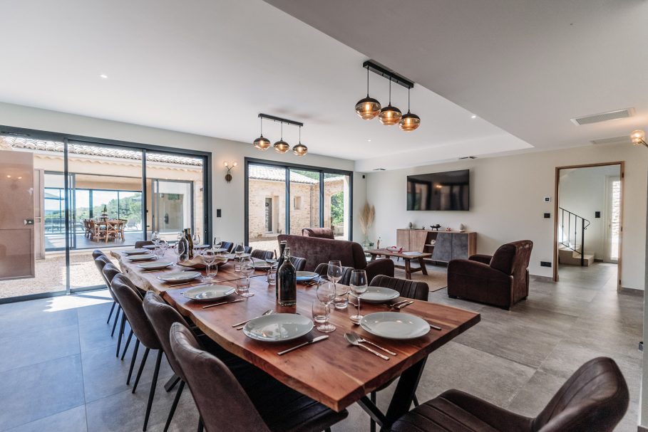 Grande table en bois massif dressée pour un dîner de groupe dans une villa de luxe – Access Flow Retreats